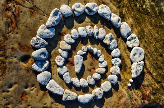 Textured pebbles on the sea boulder