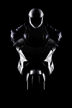 motorist on a motorcycle against black background