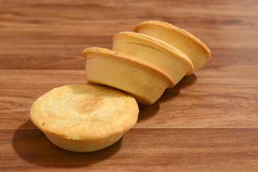 Stack of meat pies freshly baked.