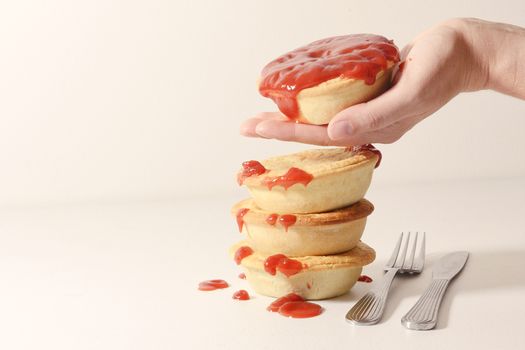 Stack of meat pies freshly baked.