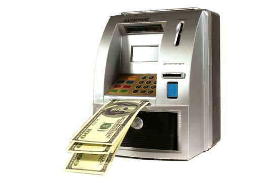 Piggy bank in the form of an ATM with hundred dollar banknotes
