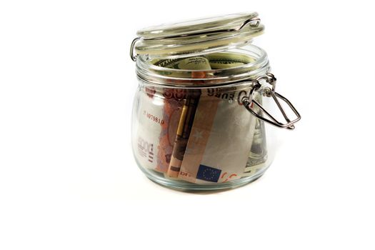 Glass jar filled with banknotes of different countries