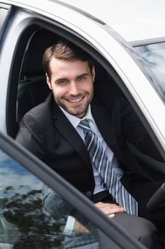 Businessman sitting in drivers seat in his car