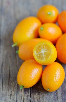 kumquat fruit on wooden table