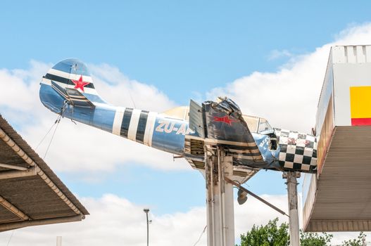 TOUWS RIVER, SOUTH AFRICA - DECEMBER 2, 2014: An aeroplane wreck mounted in such a way as if it hit the roof at a local gas station