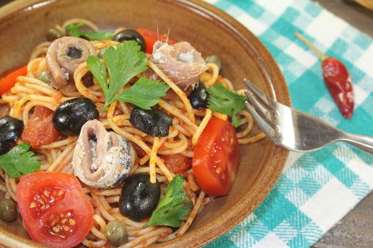 Spaghetti alla puttanesca with capers and anchovies