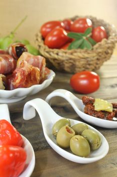 Tapas stuffed with prunes, figs and apricots on wooden plate