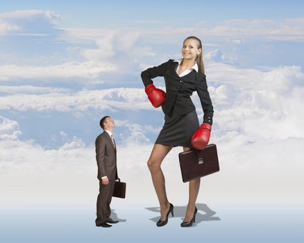 Conceptual Small Serious Businessman Staring at Giant Smiling Businesswoman with Boxing Gloves and Briefcase on White Clouds Background