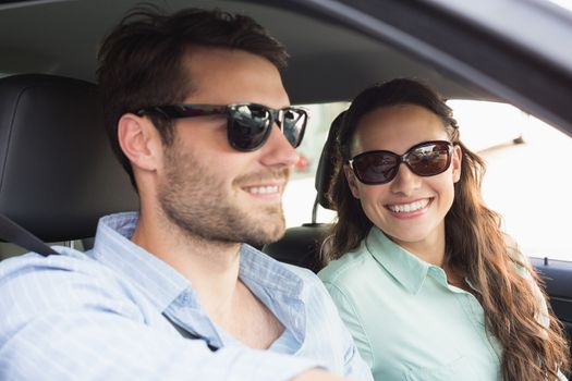 Young couple on a road trip in their car