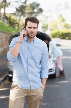 Young couple after a car breakdown at the side of the road