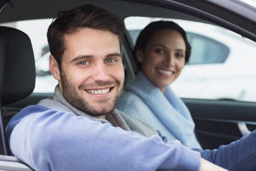 Young couple going for a drive in their car