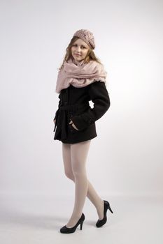 The young long-haired blond woman in French style, with beret and short coat