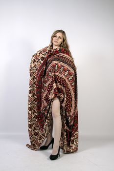 Young long-haired curly blonde woman posing wrapped in a mandala