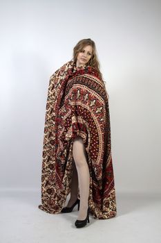 Young long-haired curly blonde woman posing wrapped in a mandala
