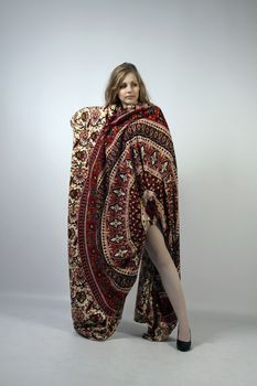 Young long-haired curly blonde woman posing wrapped in a mandala