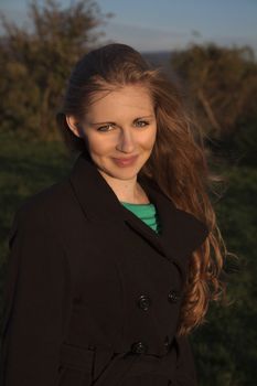 Young long-haired curly blonde woman presented beautiful natural long curly blond hair