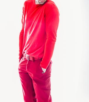 Elegant young handsome man in red clothing. Studio fashion portrait.