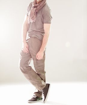 Elegant young handsome man in gray clothing. Studio fashion portrait.