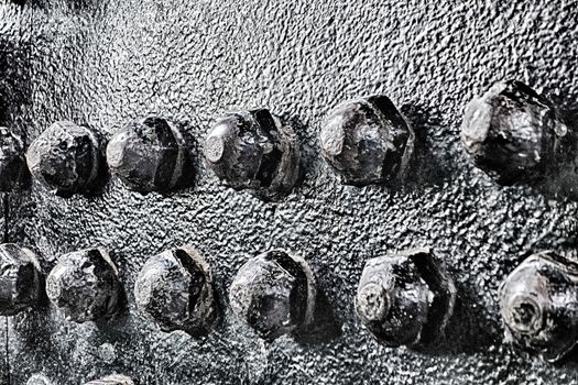 Industrial abstract background texture with black steel structure with bolts and rivets