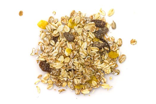 Heap of muesli isolated on white. Delicious granola cereal mix, with dried fruit and seeds.