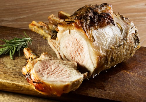 Grilled meat with rosemasy on cutting board