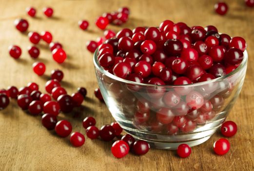 Fresh ripe red cranberries on glass cup