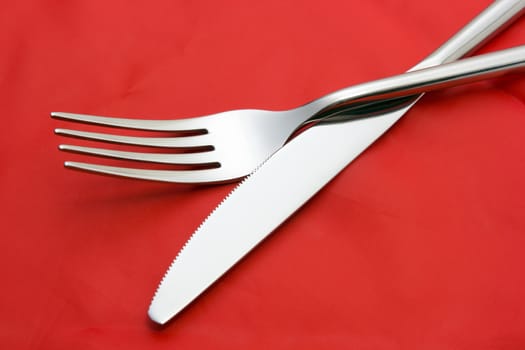 Fork and knife on red tablecloth