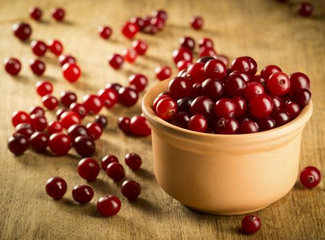 Fresh cranberries on wooden background