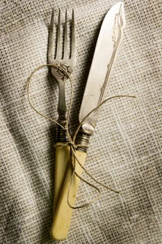 Vintage silverware on burlap background