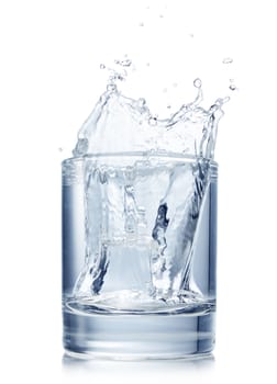 Splash from ice cube in a glass of water, isolated on the white background