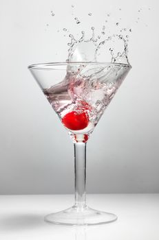 Splash of cherry in martini glass