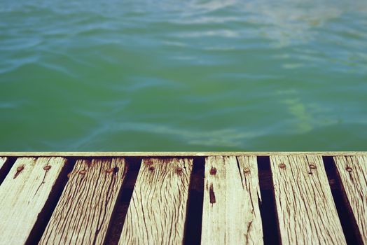 Wooden deck floor over tropical summer time sea with clipping path for adding your own background