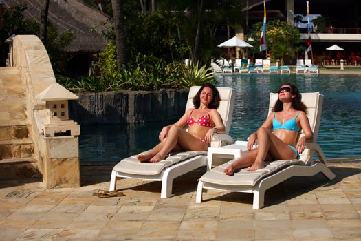 Two young girls on swimming pool