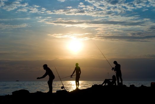 People fish. The sea, evening, the beautiful sky.