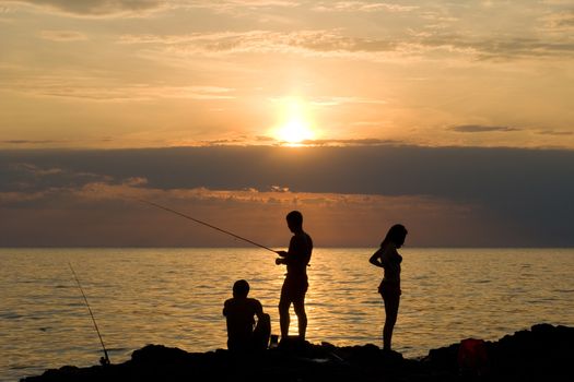 People fish. The sea, evening, the beautiful sky.