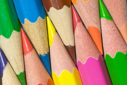 Multi-coloured pencils are close each other.