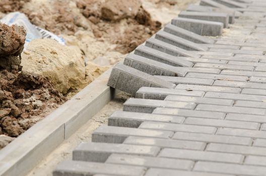 Laying of paving slabs to the curb