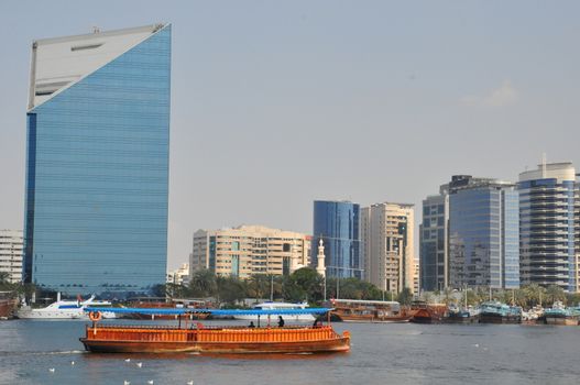 Dubai Creek in Dubai, UAE. The notable buildings along the Deira Creek are Deira Twin Towers, Dubai Creek Tower, National Bank, and Chamber of Commerce.