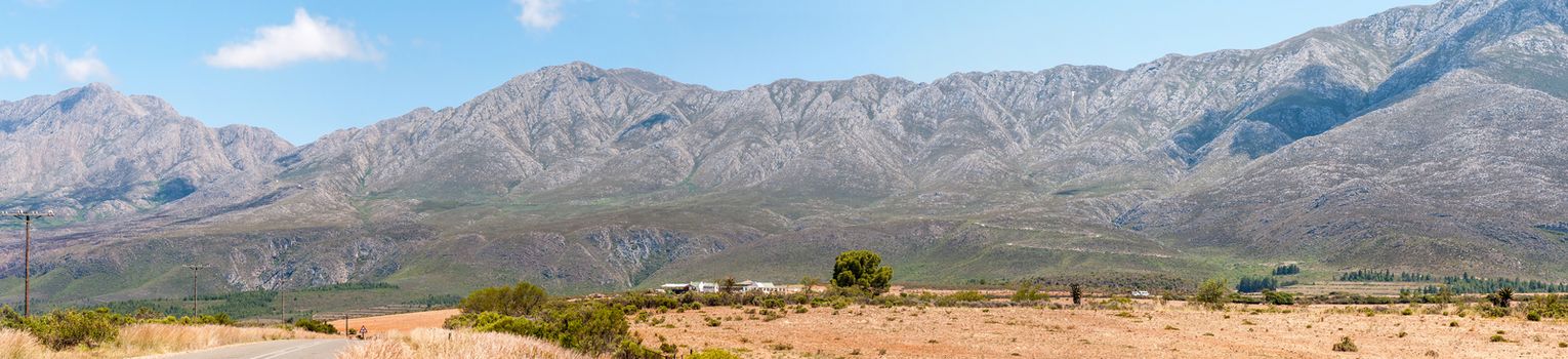 SWARTBERG PASS, SOUTH AFRICA - JANUARY 2, 2015: The historic Swartberg (Black Mountain) Pass is seen in the background with Kobus se Gat in the foreground. The pass is a declared national monument.
