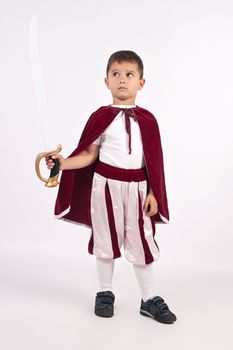 Boy dressed in an oblique Prince, holding in his hand a sword