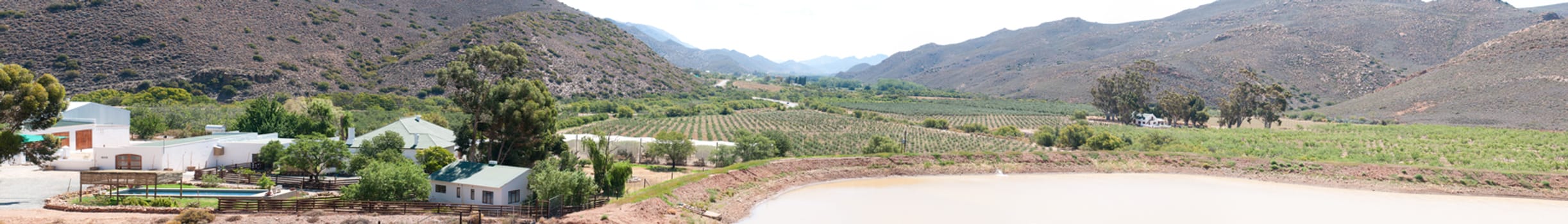 KREDOUW PASS, SOUTH AFRICA - JANUARY 2, 2015: View from the pass into the fertile Prince Albert Valley on an overcast day. Many vineyards are visible