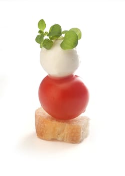 Isolated canape with tomato and mozzarella on the toothpick