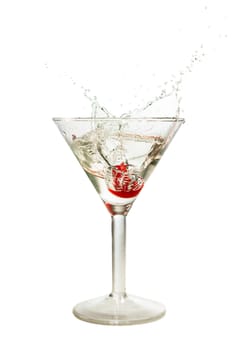 Splash of cherry in martini glass isolated on white background