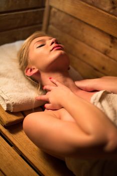 Young woman relaxing in a sauna, taking a break from her busy schedule, taking care of herself, enjoying the wellness benefits her job provides