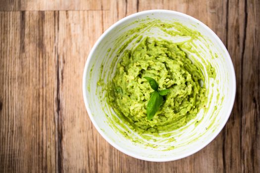 Fresh avocado guacamole on rice bred with basil