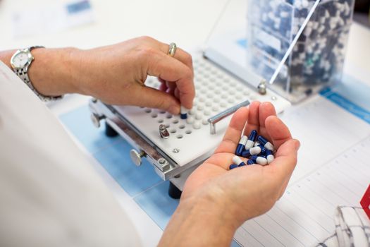 medical pills industry factory and production indoor, worker's hands handling pills