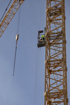 Worker on Construction Crane Elevator, descending
