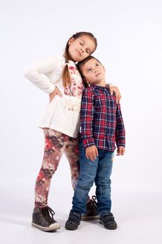 Girl with plait boy in checkered shirt, standing together