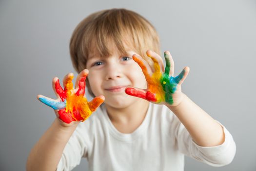 little girl and boy hands painted  in colorful paints