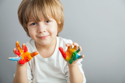 little girl and boy hands painted  in colorful paints